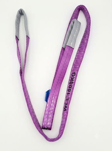 Purple and green round lifting slings coiled on a white background